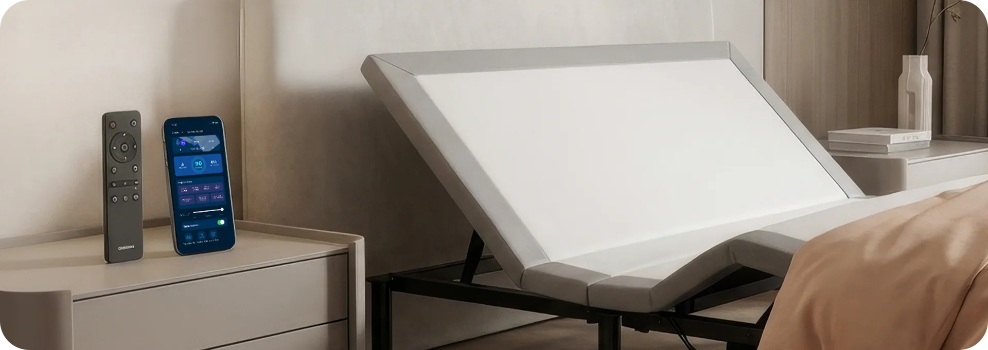 Ascend+ Smart Base reclined, with the app and remote control on a bedside table